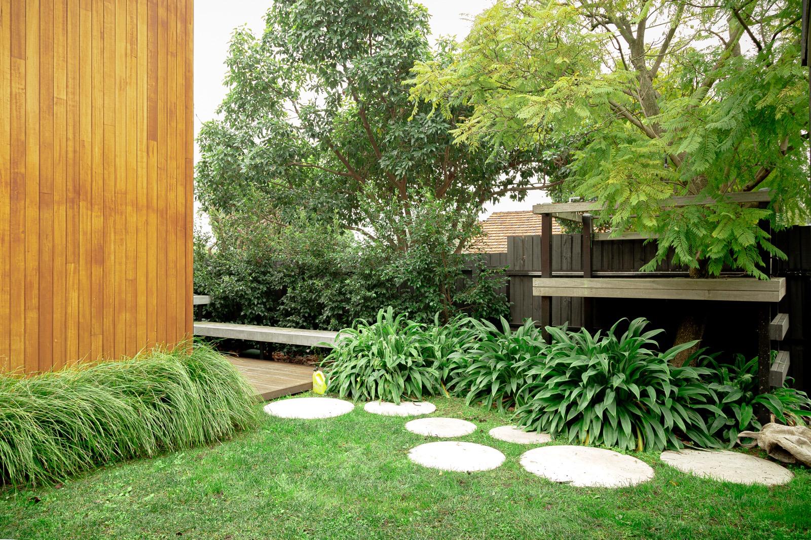 A recent Eden design and build, a landscaped garden with stepping stones, timber cladding and a shaded deck