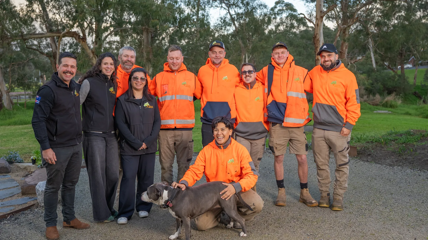 The full Eden Building & Landscaping team lined up together with the team dog